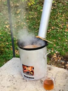 a pot of food with smoke coming out of it at Cabana Nisipoasa in Râu de Mori