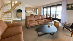a living room with a couch and a table at Waterrijk Oesterdam Resort Villas in Tholen