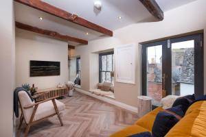 a living room with a couch and a table at Sullivans Loft in Newlyn