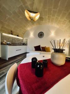 a bedroom with a white bed with a red rug at Il Nicchio in Matera