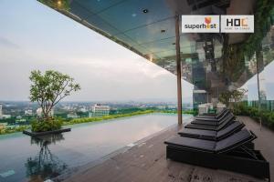 a building with a swimming pool with a sign on it at Deluxe 2-Bedroom Suite with Pool & Gym in Chiang Mai