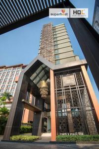 a building in front of a tall building at Deluxe 2-Bedroom Suite with Pool & Gym in Chiang Mai