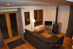 a living room with a couch and a wood stove at Erne River Lodge in Belturbet