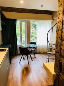 a kitchen with a glass table and chairs in a room at Grace Chapinero in Bogotá