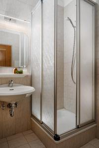 a bathroom with a shower and a sink at A. Paolo Apartments in Vigo di Fassa +180 photos