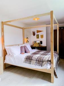This must be the place - Skye, Carbost في كاربوست: غرفة نوم بسرير مع اطار خشبي