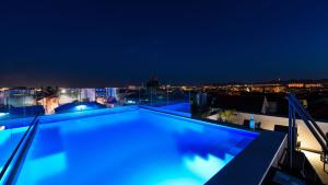 a swimming pool on the roof of a building at night at Rooftop heated pool Villa Jelena in Zadar