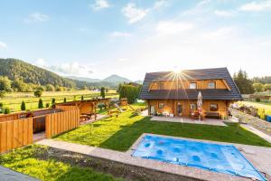 an image of a house with a swimming pool at Drevenice Liptov - apartments under the mountains in Lazisko