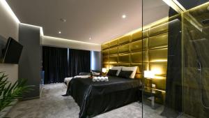 a hotel room with a bed and a glass wall at Rooftop heated pool Villa Jelena in Zadar