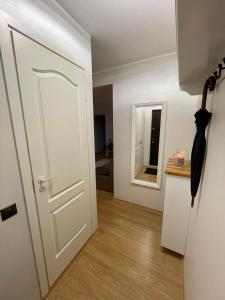 an open door with an umbrella next to a room at Keskuse apartment with a balcony in Haapsalu