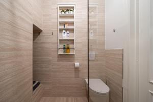 a bathroom with a toilet and a shower at Library House "Bibliotekas nams" - Apartment with Park View in Rīga