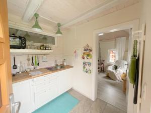 a kitchen with a sink and a refrigerator at Blütenstöckl in Frutten