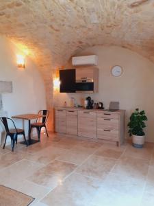 a kitchen and dining room with a table and chairs at coeur de famille in Bessas