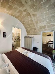 a bedroom with a large bed in a room at Il Nicchio in Matera