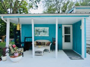 a blue shed with a table and chairs on a patio at Boho-Chic Studio - Unit 1 in Bloomington