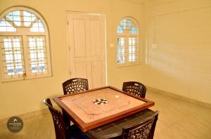 a room with a ping pong table and chairs at mangosteen holidays in Vythiri