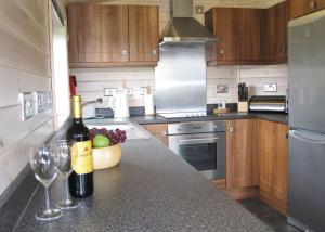 a kitchen with two bottles of wine and two wine glasses at Wighill Manor Lodges in Newton Kyme