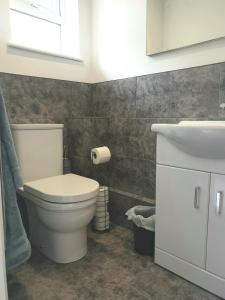 a bathroom with a white toilet and a sink at The Bay Studio 2 - Broadstairs in Broadstairs