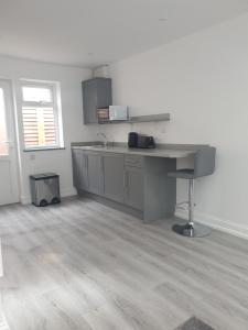 an empty kitchen with a desk in a room at The Bay Studio 2 - Broadstairs in Broadstairs