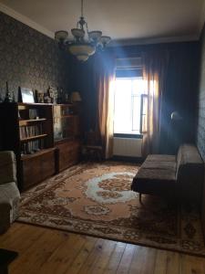 a living room with a couch and a rug at дом в новханах у моря in Baku