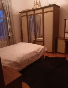 a bedroom with a bed with a wooden canopy at дом в новханах у моря in Baku