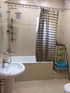 a bathroom with a tub and a sink and a shower at дом в новханах у моря in Baku
