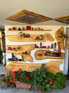 a display of wooden trains on a wall with flowers at Vila Mišur in Pirot