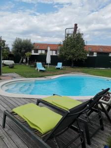 a swimming pool with two lounge chairs next to it at Casas Zé Pinto in Hospital