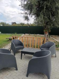 a group of chairs and a bench on a patio at Casas Zé Pinto in Hospital