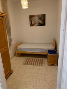 a small bedroom with a bed and a picture on the wall at Mittelmeer Villa 