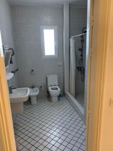 a bathroom with a toilet and a sink and a shower at Mittelmeer Villa 