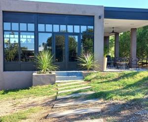 a house with plants in front of it at Cabañas Mina Clavero La Amelia in Mina Clavero