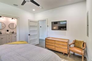 a bedroom with a bed and a desk and a tv at Modern Norfork House with Patio on White River! in Norfork