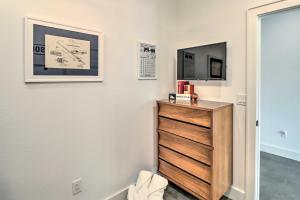 a room with a dresser and a tv on a wall at Modern Norfork House with Patio on White River! in Norfork +26 photos