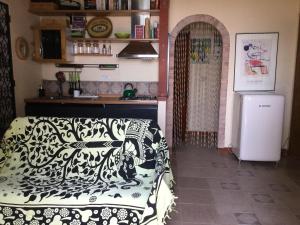 a kitchen with a couch and a refrigerator in a room at Cottage Torre Elena - Staletti in Stalettì