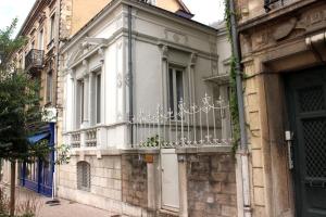 a white building with a balcony on a street at Sublime appartement, chic et confortable. in Bourg-en-Bresse