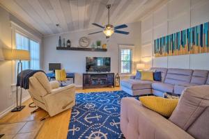 a living room with a couch and chairs and a tv at Peaceful Wilmington Home Near Beach and Downtown! in Carolina Beach