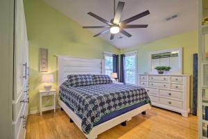 a bedroom with a bed and a ceiling fan at Peaceful Wilmington Home Near Beach and Downtown! in Carolina Beach