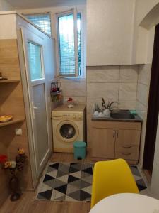 a small kitchen with a washing machine and a sink at Guest House, Old-Si in Tbilisi City