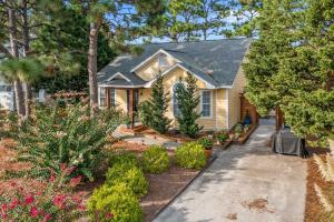 a house with a garden in front of it at Peaceful Wilmington Home Near Beach and Downtown! in Carolina Beach