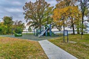 a playground with a slide in a park at Airy Cottage Close to Rock Lake with Fire Pit! in Lake Mills