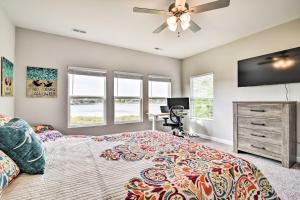 a bedroom with a bed and a ceiling fan at Waterfront Paradise with Deck about half Mi to Beach in North Camellia Acres