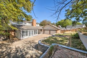 a house with a driveway and a garage at Pet-Friendly Home about 6 Mi to Downtown Fort Worth! in Fort Worth