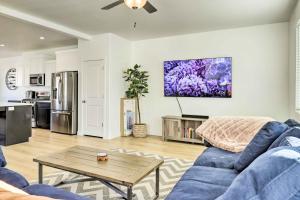 a living room with a blue couch and a table at Modern Townhome - 8 Mi to Thanksgiving Point! in American Fork