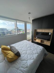 a bedroom with a large bed and a fireplace at Departamento con piscina vista panorámica más estacionamiento in Coquimbo