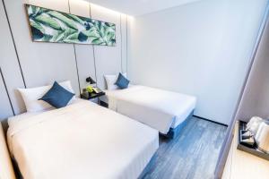 Ein Bett oder Betten in einem Zimmer der Unterkunft Hotel COZi Oasis