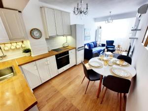 a kitchen and dining room with a table and chairs at VARNA NAUTICAL Apartment in Varna City