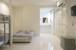 a room with two bunk beds and a hallway at Nap77 Salaya in Salaya