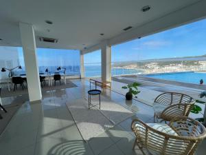 a living room with a view of the ocean at Cliffs Apartment - Astonishing view over Sesimbra bay by Trip2Portugal in Sesimbra