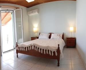 a bedroom with a large bed and a window at Xigia hideaway - panoramic sea view house in Zakynthos Town